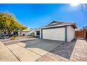 House exterior showcasing a large garage and a paved walkway at 3235 W Irma Ln, Phoenix, AZ 85027