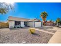 Charming single story home with a landscaped front yard and attached garage at 3235 W Irma Ln, Phoenix, AZ 85027