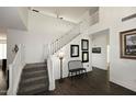 Bright entryway with staircase, bench, and dark hardwood floors at 3267 E Maplewood St, Gilbert, AZ 85297