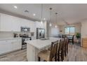 Modern kitchen with white cabinets, quartz countertops, and stainless steel appliances at 3515 N Tewa Cir, Eloy, AZ 85131