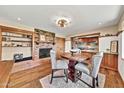 Charming dining area with exposed brick fireplace and a round dining table with upholstered chairs at 4022 E Stanford Dr, Phoenix, AZ 85018