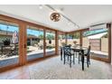 Bright sunroom with large windows, tiled flooring, and a view of the backyard patio at 4022 E Stanford Dr, Phoenix, AZ 85018