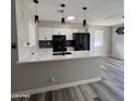 Modern kitchen with white cabinets, quartz countertops, and black appliances at 409 W Pontiac Dr # 8, Phoenix, AZ 85027