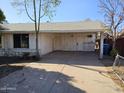 House exterior showcasing carport and front yard at 4132 N 89Th Ln, Phoenix, AZ 85037