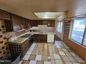 Kitchen features wood cabinets, tile floors and appliances at 4132 N 89Th Ln, Phoenix, AZ 85037