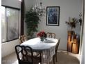 Inviting dining room with large window and an elegant chandelier at 440 S Val Vista Dr # 52, Mesa, AZ 85204