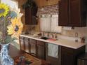 Traditional kitchen featuring dark wood cabinets and a patterned window awning at 440 S Val Vista Dr # 52, Mesa, AZ 85204