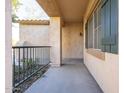 Covered patio with a concrete floor and metal railing at 5211 W Maldonado Rd, Laveen, AZ 85339