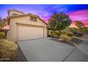 Tan colored house with a two-car garage and driveway at 5211 W Maldonado Rd, Laveen, AZ 85339