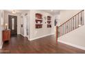 Entryway with hardwood floors, built-in shelves and staircase at 581 W Reeves Ave, San Tan Valley, AZ 85140