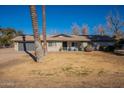 Ranch-style house featuring a spacious lawn and attached garage at 616 E Country S Plz, Gilbert, AZ 85234