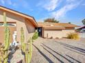 Front entryway with a black door and stone accents at 6554 E Dallas St, Mesa, AZ 85205