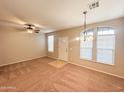 Bright living room with neutral carpeting and large windows at 6710 E University Dr # 147, Mesa, AZ 85205