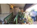 Mobile home entrance with stairs, plants, and covered porch at 8120 E Boise St, Mesa, AZ 85207