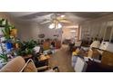 Living room with furniture, boxes, and a ceiling fan at 8120 E Boise St, Mesa, AZ 85207