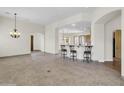 Open concept dining room with breakfast bar and tile floors at 8494 E Gilded Perch Dr, Scottsdale, AZ 85255