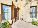 Inviting entryway with a brick walkway and charming potted plants at 8494 E Gilded Perch Dr, Scottsdale, AZ 85255