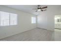 Bright bedroom with light flooring and a double door closet at 9321 W Hillcrest Pl, Arizona City, AZ 85123