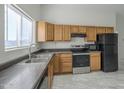 Modern kitchen featuring wood cabinets and stainless steel appliances at 9321 W Hillcrest Pl, Arizona City, AZ 85123