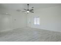 Spacious living room with tile flooring and ceiling fan at 9321 W Hillcrest Pl, Arizona City, AZ 85123