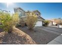 Two-story house with a white garage door and landscaping at 109 E Milada Dr, Phoenix, AZ 85042
