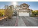 Two-story house with a white garage door and landscaping at 109 E Milada Dr, Phoenix, AZ 85042