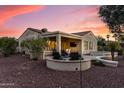 Expansive backyard featuring a covered patio, built-in seating, and mature landscaping, perfect for entertaining at 12942 W Sola Dr, Sun City West, AZ 85375