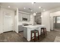Modern kitchen with gray cabinets, white countertops, and stainless steel appliances at 14627 W Valentine St, Surprise, AZ 85379
