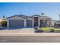 Modern single story home with gray exterior and two-car garage at 2743 N Lema Dr, Mesa, AZ 85215