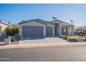 Two-car garage, gray exterior, and a landscaped front yard with artificial turf at 2743 N Lema Dr, Mesa, AZ 85215