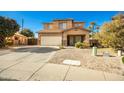 Two-story house with a beige exterior, attached garage, and desert landscaping at 33602 N Cobble Stone Dr, San Tan Valley, AZ 85143