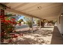 Covered patio with bougainvillea and view of street at 430 S 81St Pl, Mesa, AZ 85208