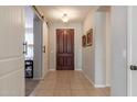 Bright entryway with tile floors and a wood door at 735 W Basswood Ave, San Tan Valley, AZ 85140