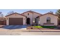 Single-story home with a two-car garage and landscaped front yard at 735 W Basswood Ave, San Tan Valley, AZ 85140