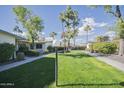 Landscaped community courtyard with walkways and lush green grass at 10533 W Wheatridge Dr, Sun City, AZ 85373