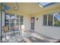 Inviting front patio with seating area, bird feeder and tiled flooring at 10533 W Wheatridge Dr, Sun City, AZ 85373