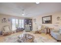 Spacious living room featuring comfortable seating and a large wood coffee table at 10533 W Wheatridge Dr, Sun City, AZ 85373