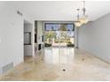 Spacious dining room with travertine floors and sliding glass doors leading to a patio at 10796 N 78Th St, Scottsdale, AZ 85260