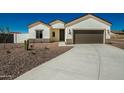 New home exterior showcasing a clean design and driveway at 13717 S Huntington Rd, Arizona City, AZ 85123