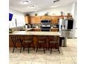 Kitchen boasts granite countertops, stainless steel appliances, and a breakfast bar at 143 W Michelle Dr, Phoenix, AZ 85023