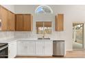 Modern kitchen with white cabinets, stainless steel appliances, and a quartz countertop at 1651 E Countrywalk Ln, Chandler, AZ 85225