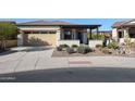 Single-story home with a covered patio and well-manicured landscaping at 17510 W Glenhaven Dr, Goodyear, AZ 85338