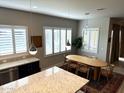 Kitchen dining area with wood table and chairs near large windows at 1957 W Chisum Trl, Phoenix, AZ 85085