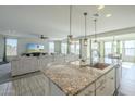 Kitchen with granite countertops, stainless steel appliances, and an island at 20121 W Lilac St, Buckeye, AZ 85326