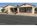 Tan single-story home with palm trees and screened carport at 3301 S Goldfield Rd # 2068, Apache Junction, AZ 85119