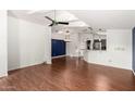 Open living area with hardwood floors and an adjacent kitchen at 3301 S Goldfield Rd # 2068, Apache Junction, AZ 85119