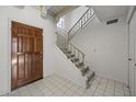 Tiled entryway with wooden door and staircase at 6249 N 78Th St # 58, Scottsdale, AZ 85250