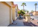 Small front patio with two rocking chairs and desert landscaping at 6877 S Oakmont Dr, Chandler, AZ 85249