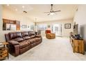 Living room with leather couches and view into kitchen and dining area at 6877 S Oakmont Dr, Chandler, AZ 85249