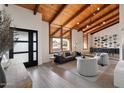 Spacious living room with vaulted wood ceilings and a floor-to-ceiling fireplace at 6936 E Friess Dr, Scottsdale, AZ 85254